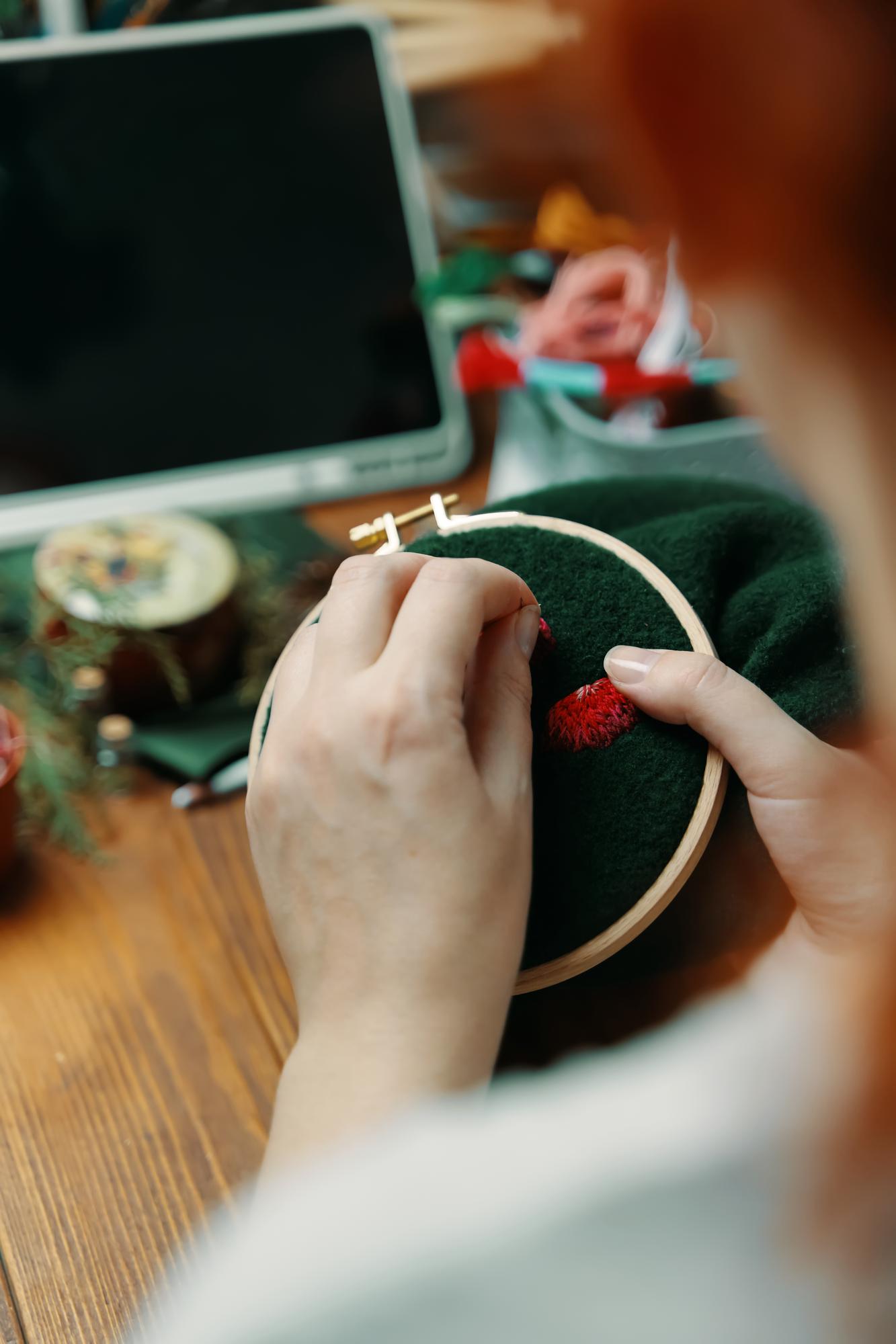 Workshop hands arranging hoop and needle